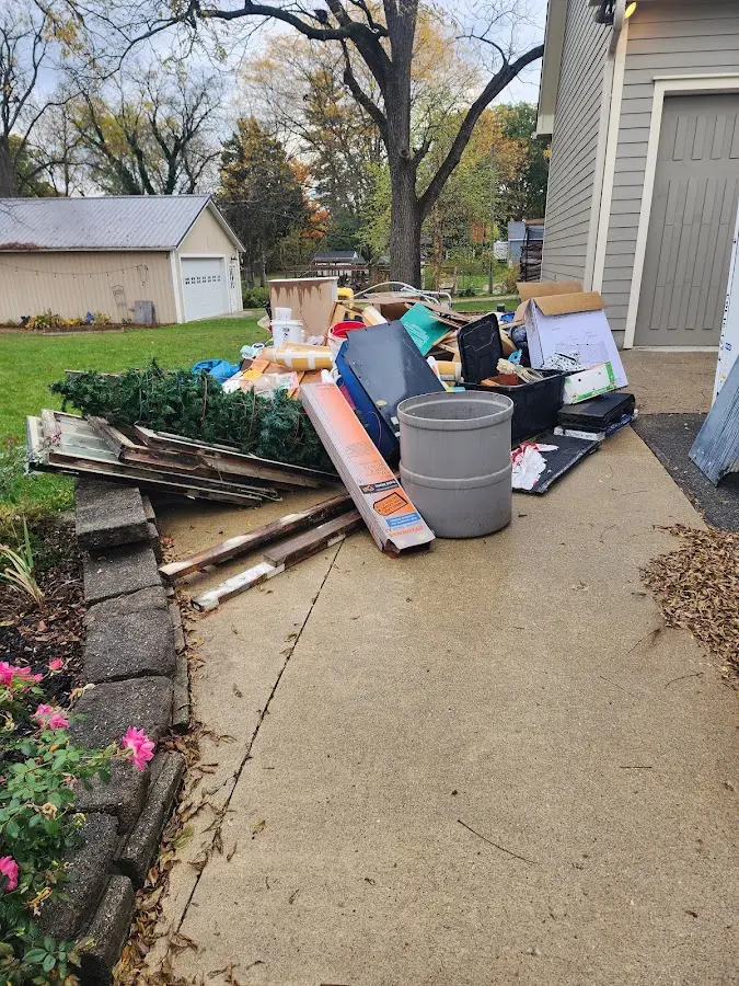 Dumpster being loaded with debris for Estate Cleanout Dumpster Rental in Kemah